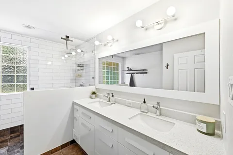 a bathroom with a sink double vanity and a mirror