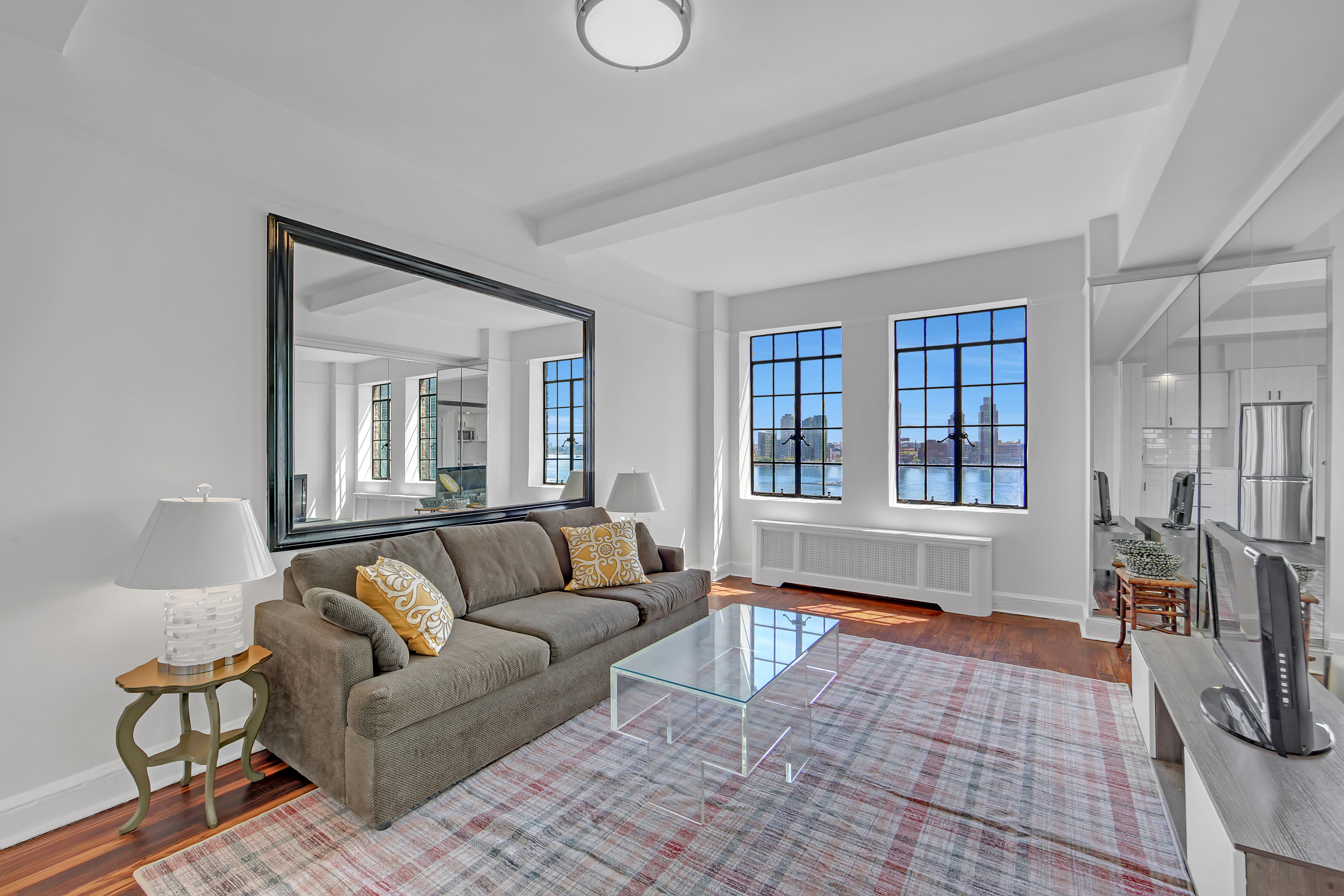 5 Tudor City Place, Unit 625 Manhattan, NY 10017 - Photo 3 of 11 a living room with furniture and a window