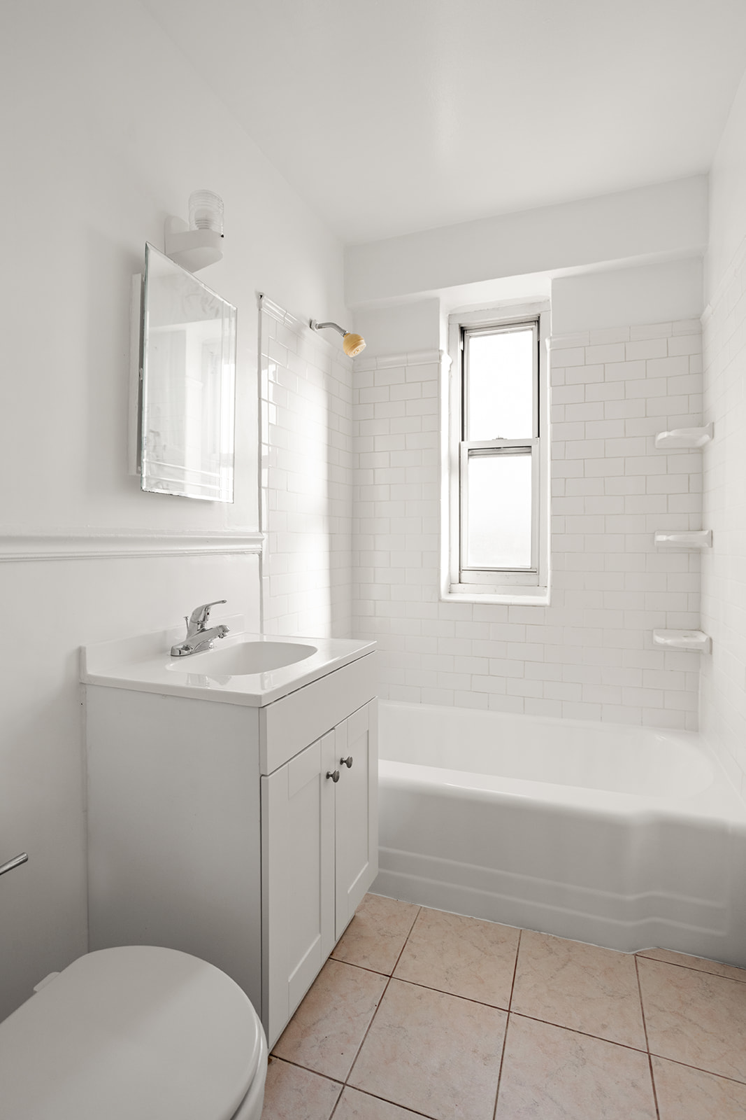 473 FDR Drive, Unit K1401 Manhattan, NY 10002 - Photo 7 of 11 a bathroom with a sink a toilet and tub