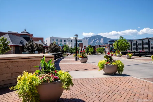 a view of a water fountain and a bench in the patio