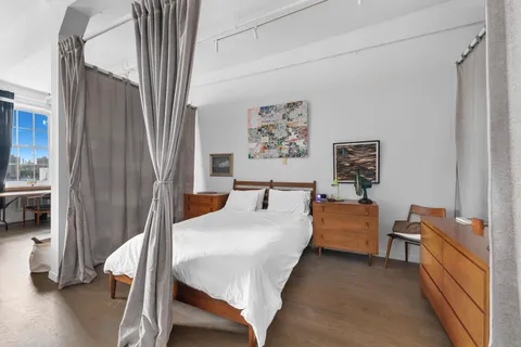 a bedroom with a bed and a chandelier