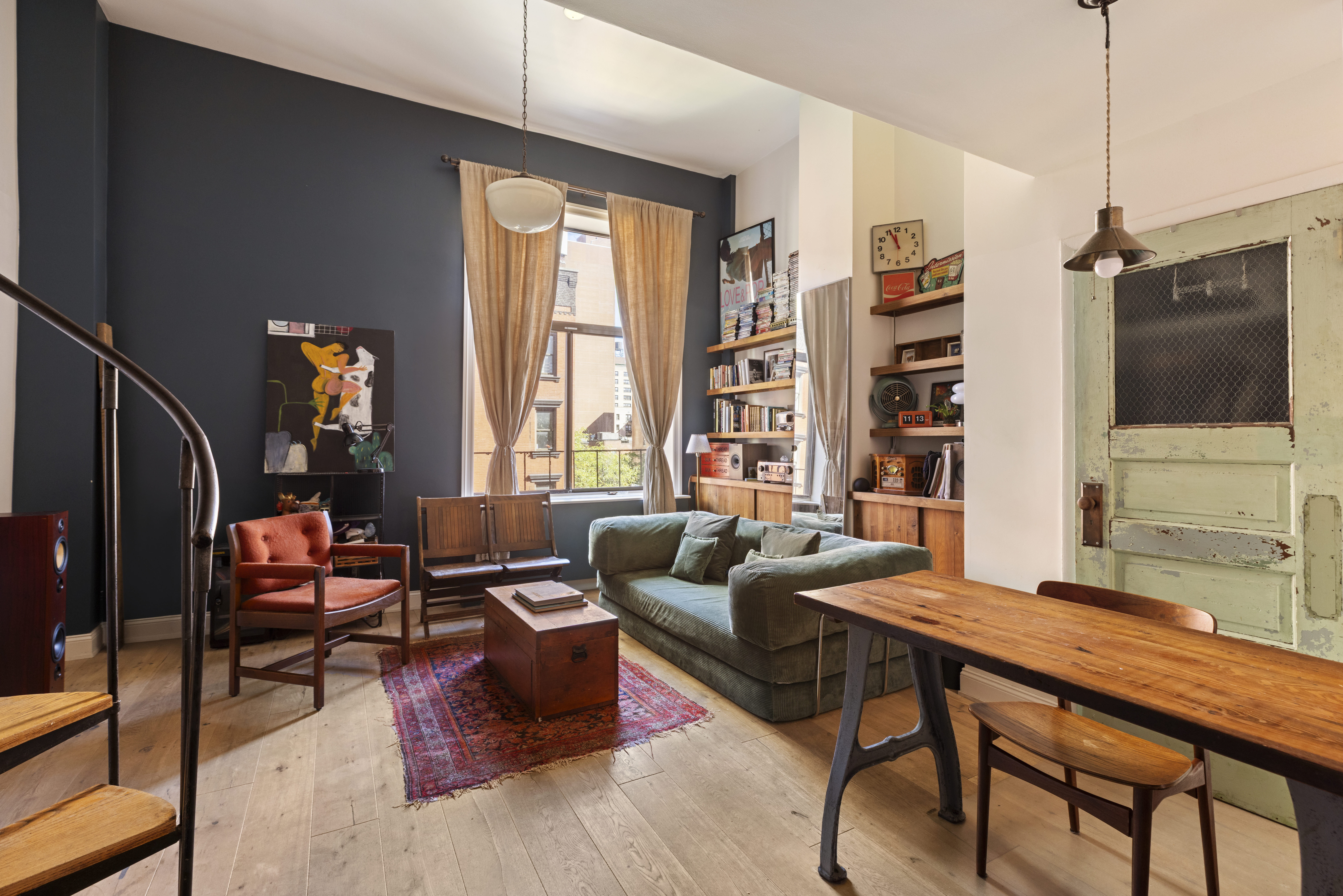 a living room with furniture a window and a flat screen tv