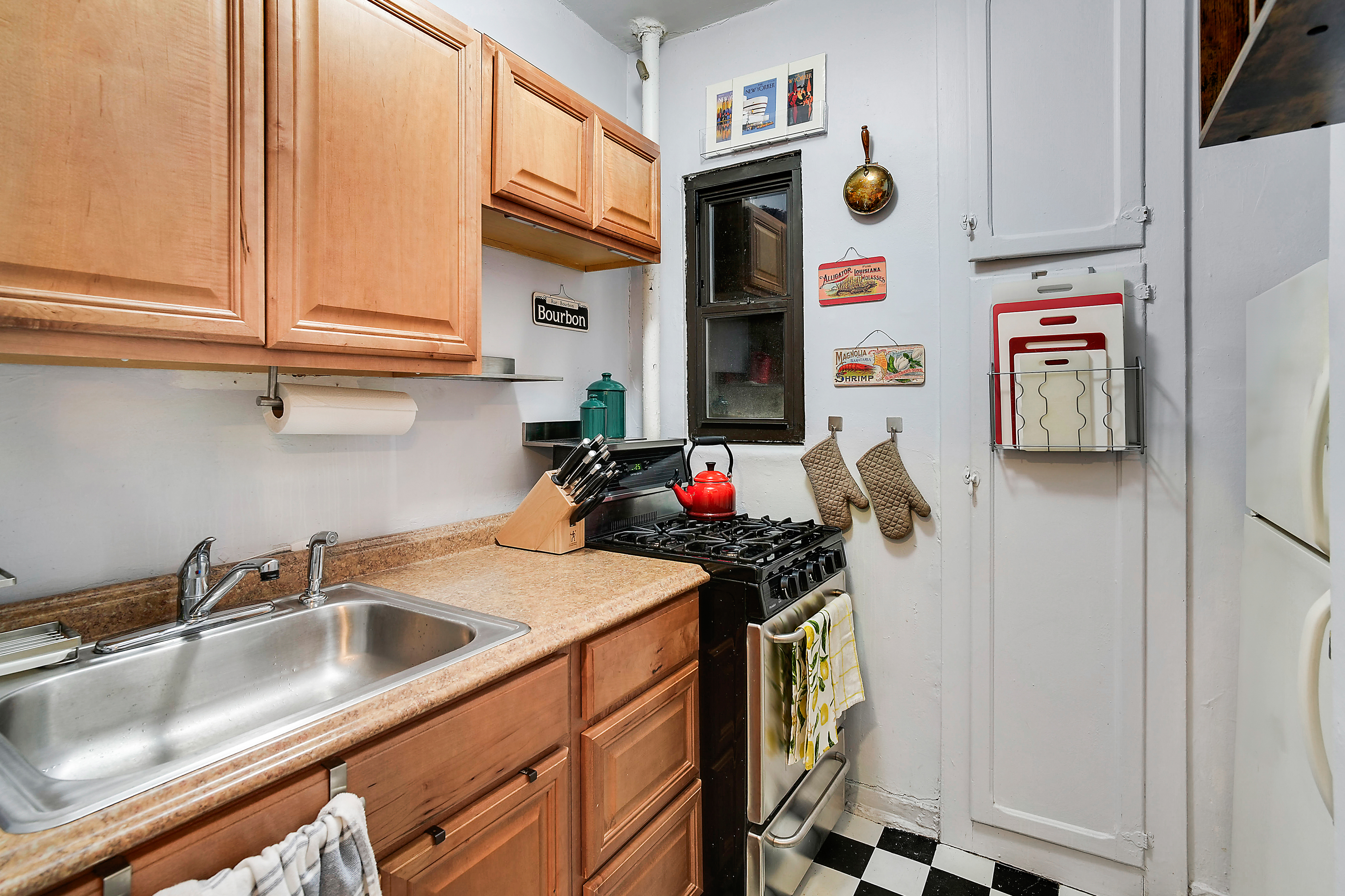 240 East 24th Street, Unit 4G Manhattan, NY 10010 - Photo 5 of 10 a kitchen with stainless steel appliances a sink and a refrigerator
