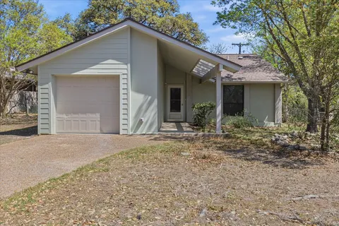 a view of a house with a yard and garage