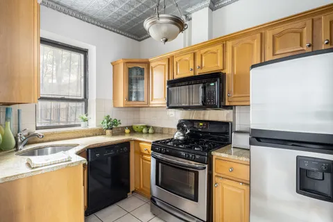 a kitchen with stainless steel appliances granite countertop a sink stove microwave and cabinets