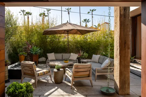 a terrace with outdoor seating and city view