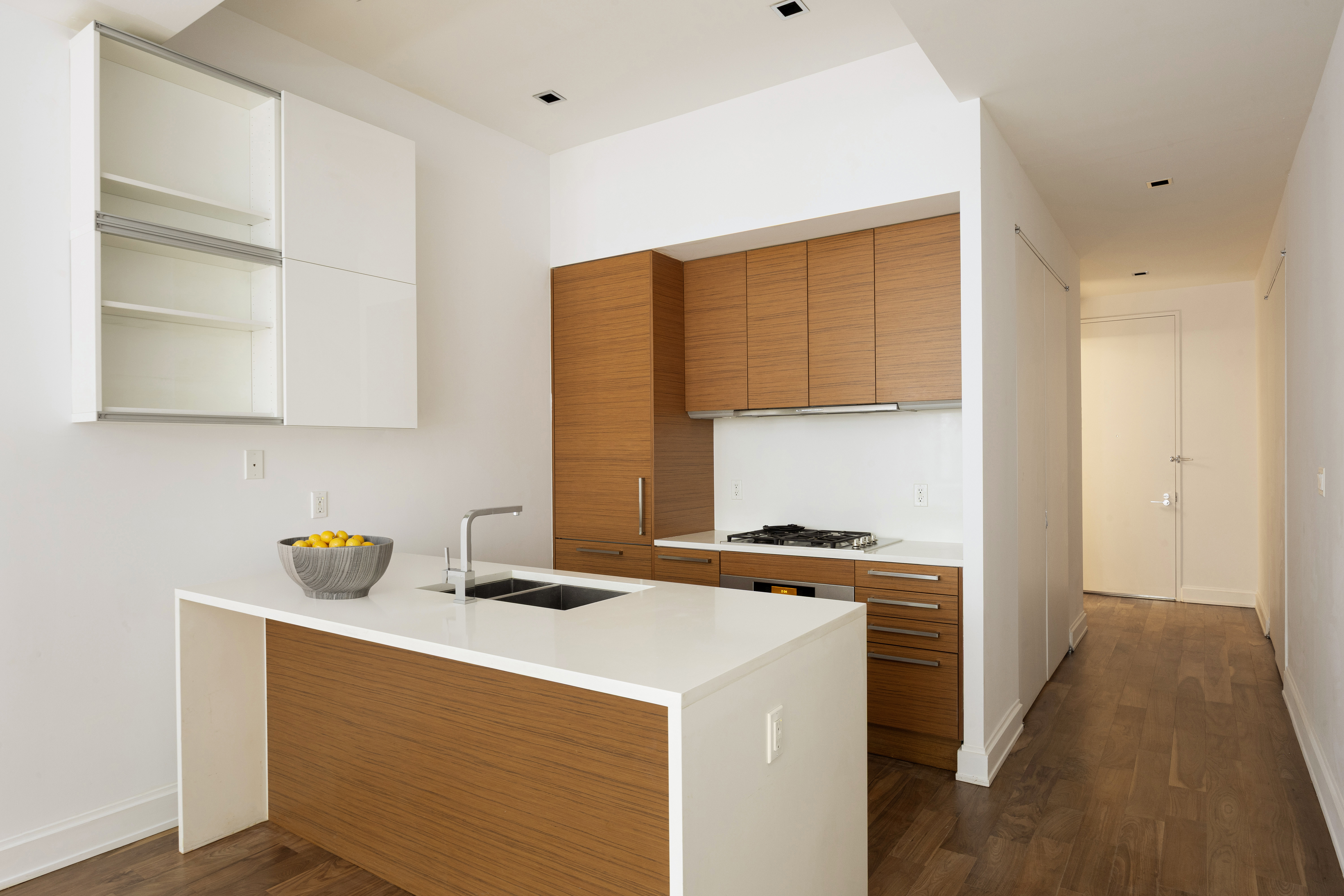140 West 22nd Street, Unit 2B Manhattan, NY 10011 - Photo 4 of 12 a kitchen with stainless steel appliances a stove a sink and a cabinets