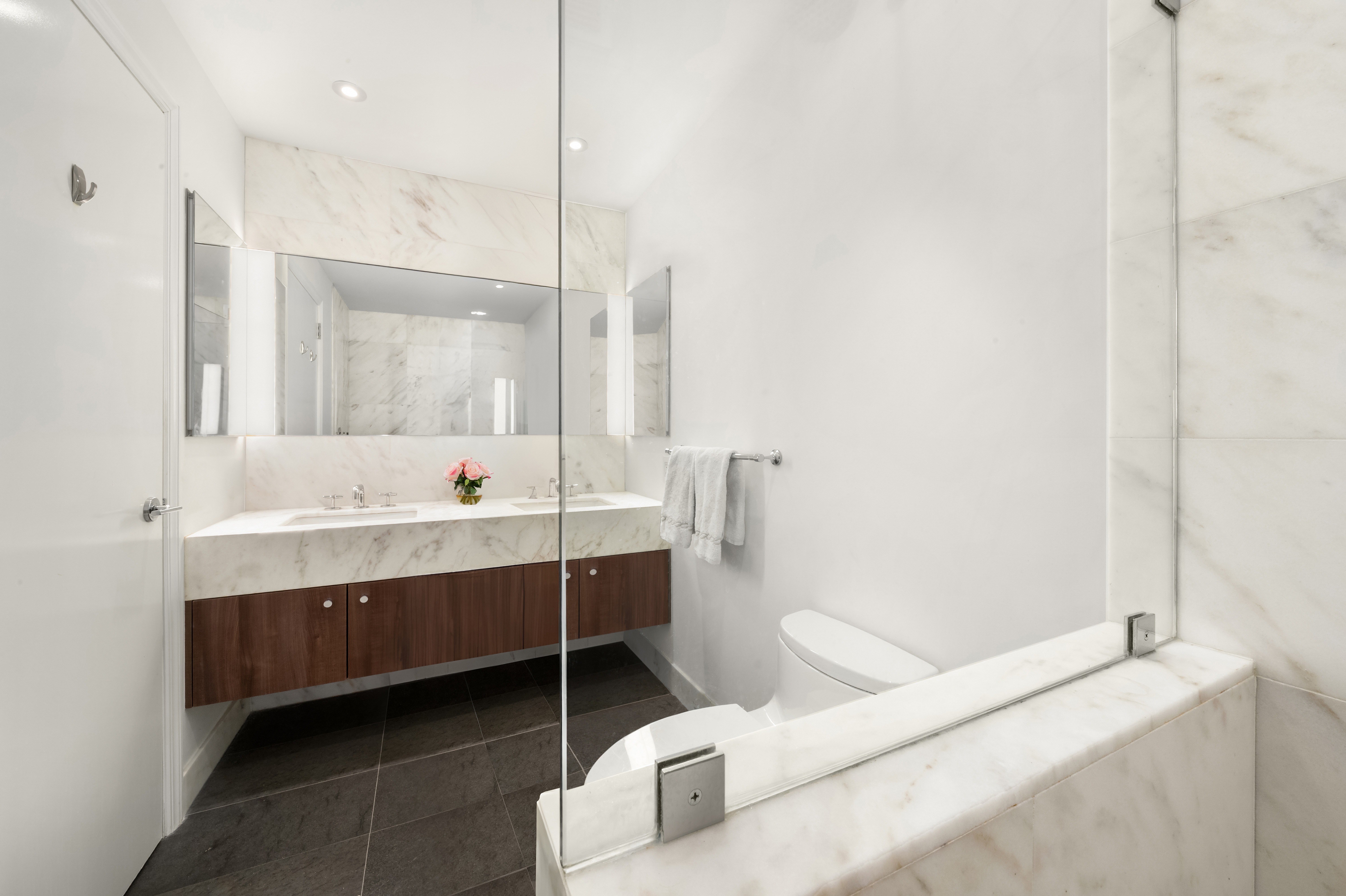 200 East 62nd Street, Unit 27A Manhattan, NY 10065 - Photo 8 of 19 a bathroom with a tub sink and mirror