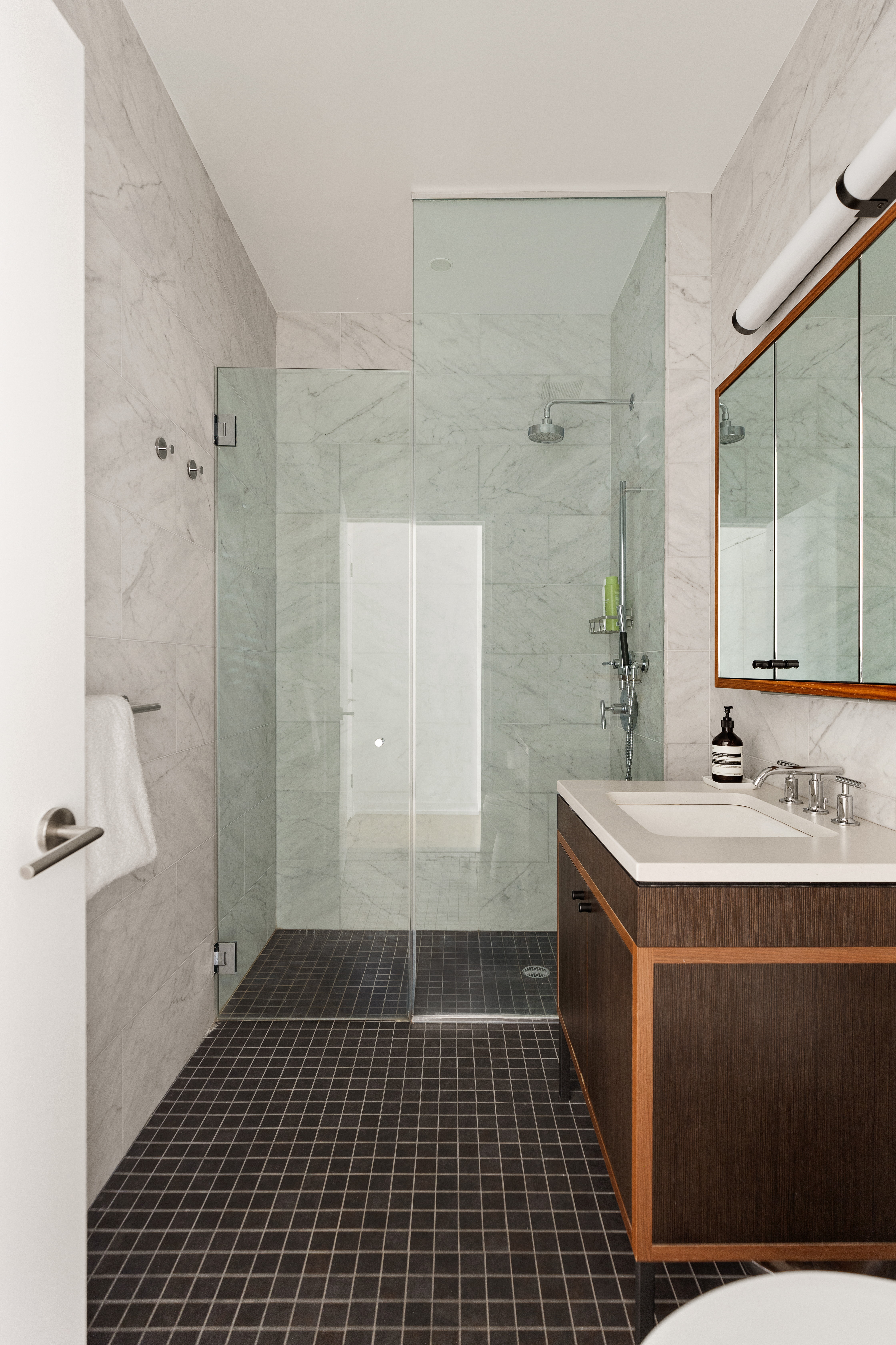 184 Kent Avenue, Unit A512 Brooklyn, NY 11249 - Photo 11 of 16 a bathroom with a sink a toilet and shower