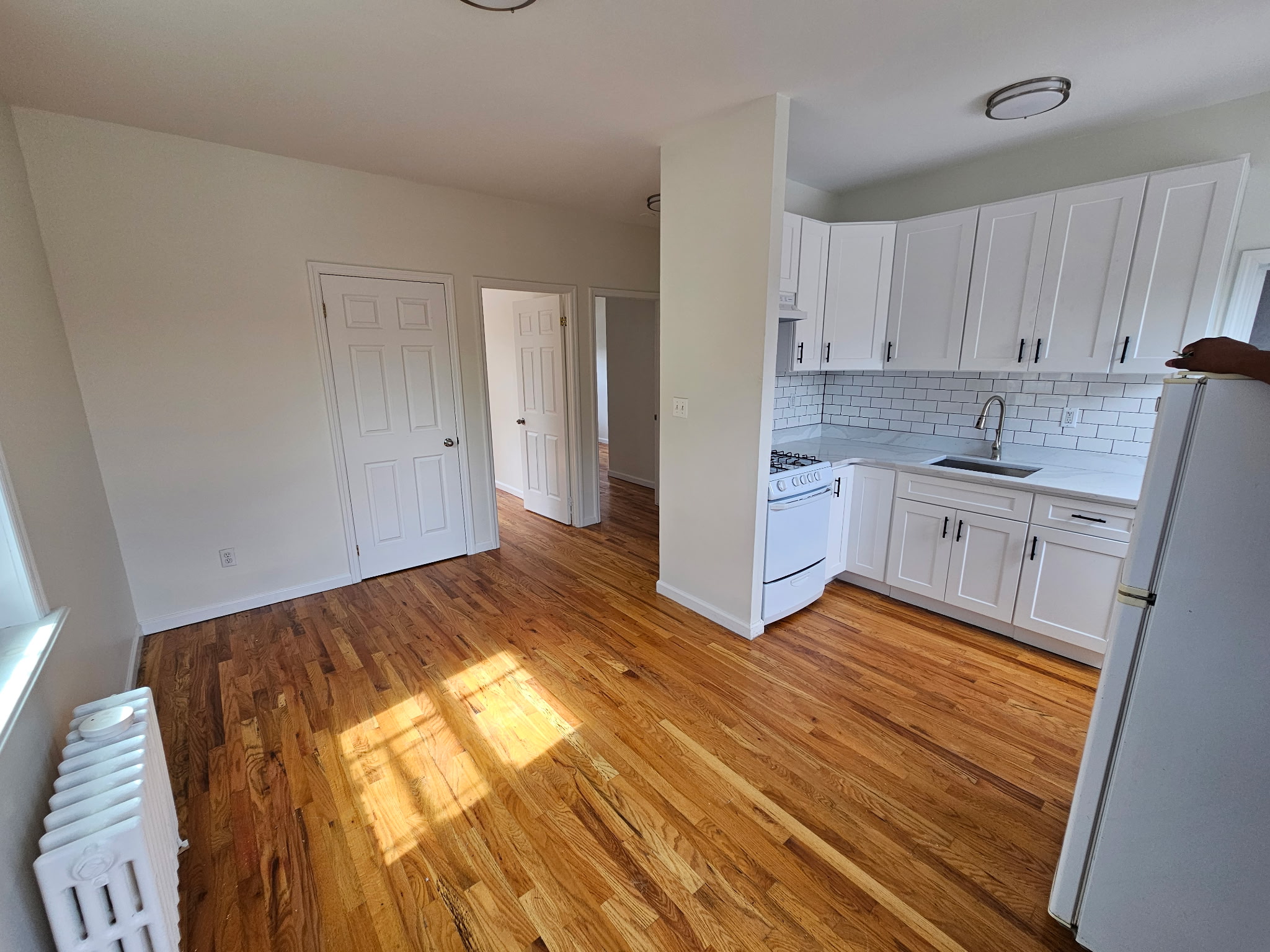 454 Lorimer Street, Unit 3 Brooklyn, NY 11206 - Photo 1 of 4 a kitchen with a sink and cabinets