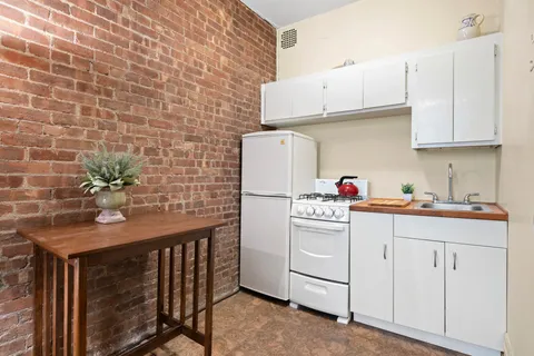 a utility room with cabinets washer and dryer