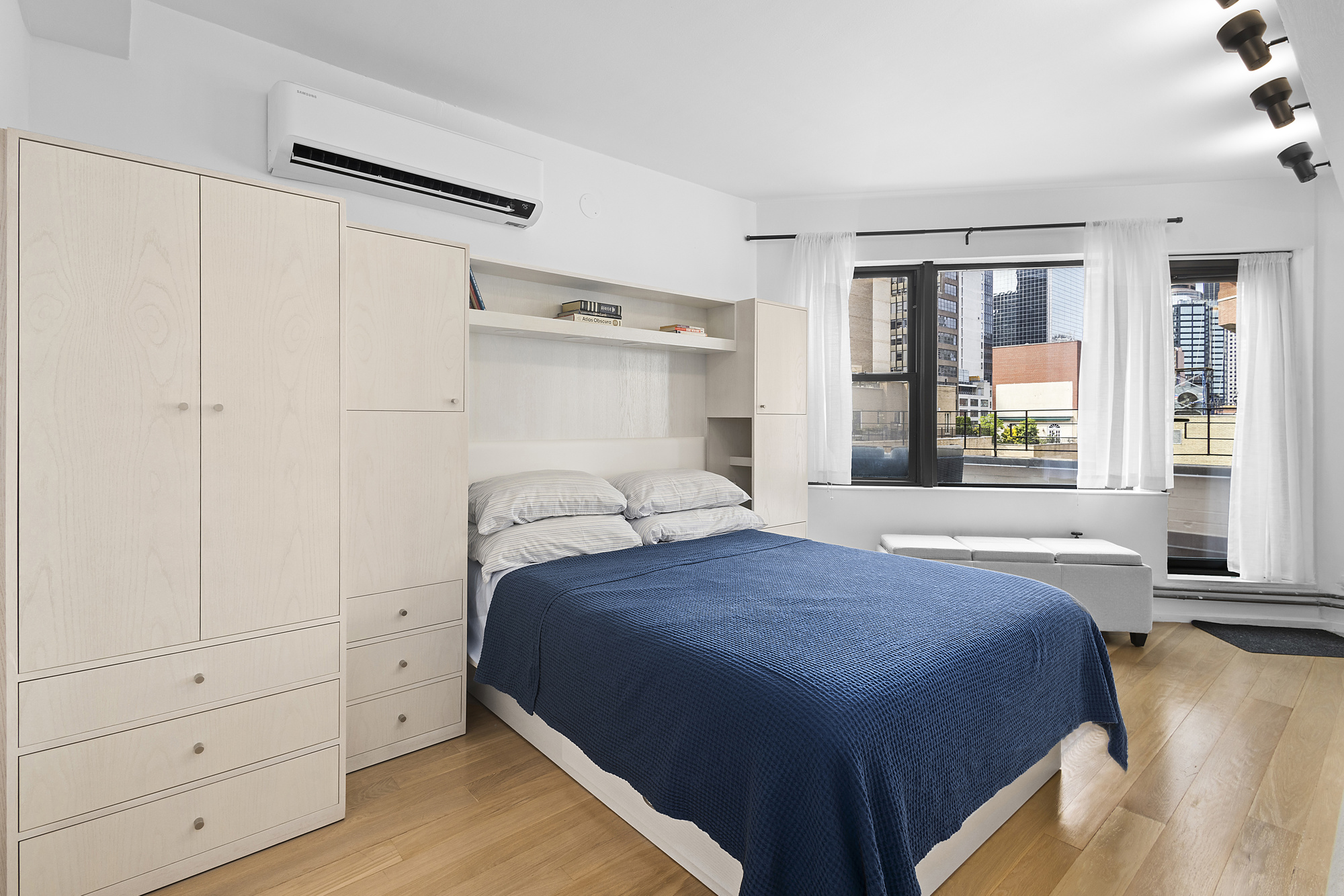 240 East 46th Street, Unit PHC Manhattan, NY 10017 - Photo 5 of 6 a bedroom with a bed and a window