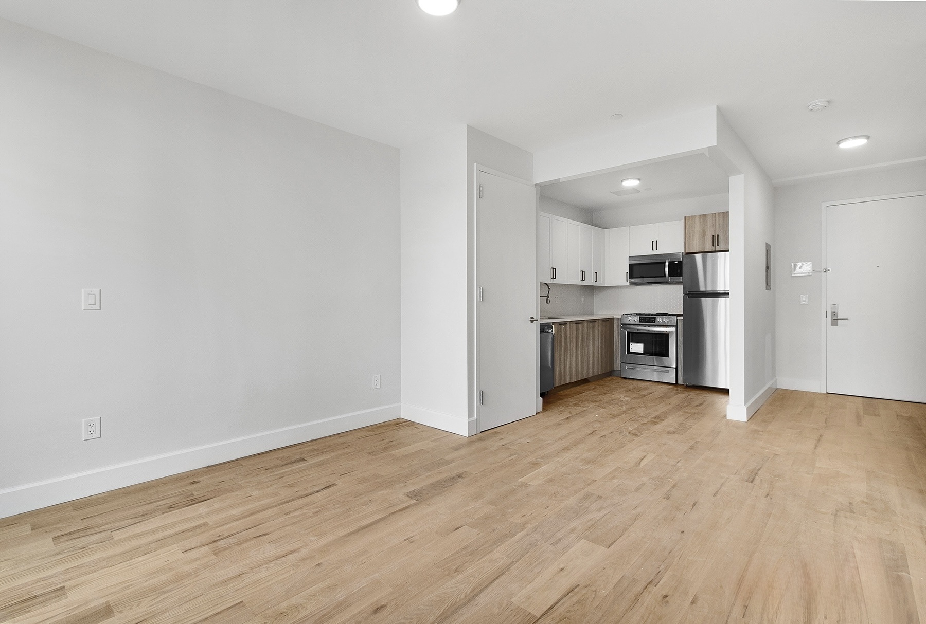 1098 Madison Street, Unit 1B Brooklyn, NY 11221 - Photo 6 of 16 a view of a kitchen with a stove top oven and cabinets