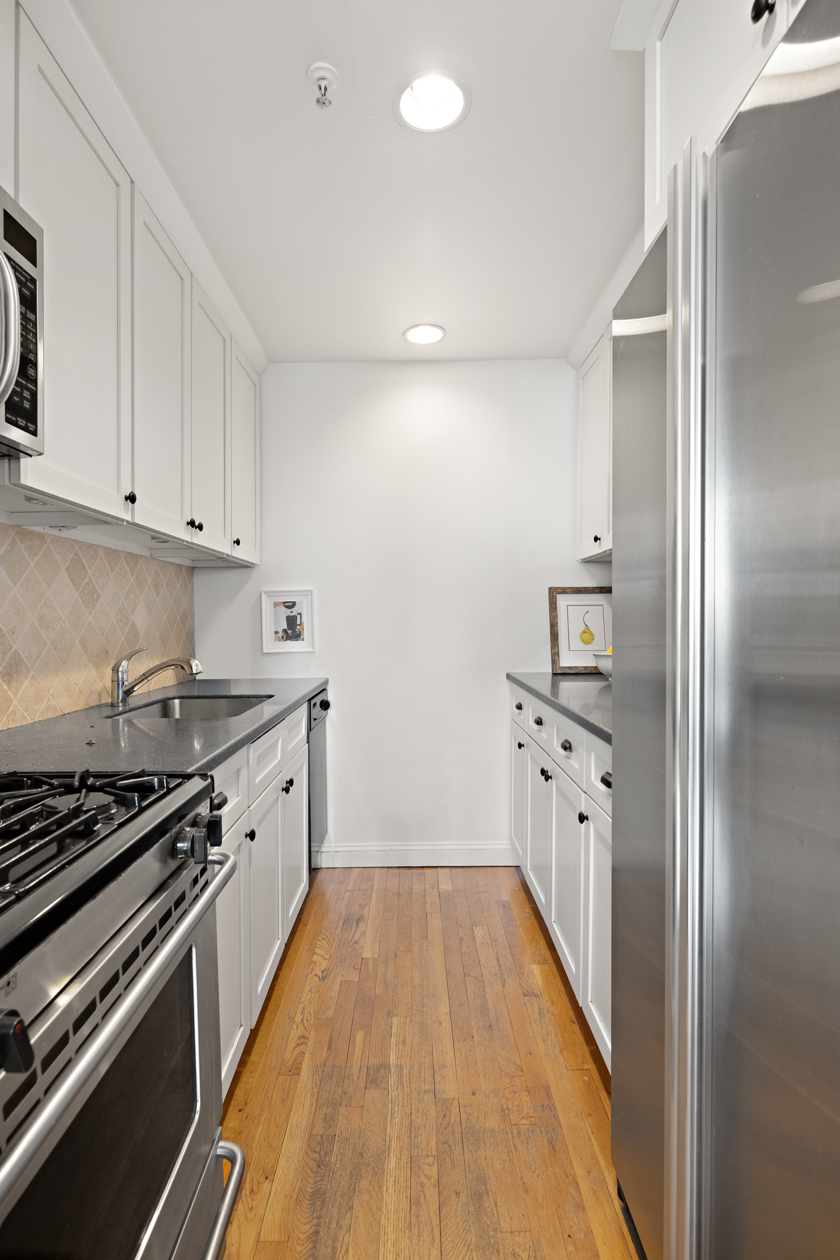 124 Atlantic Avenue, Unit A4H Brooklyn, NY 11201 - Photo 11 of 19 a kitchen with granite countertop a refrigerator and a stove top oven