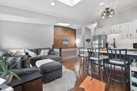 a living room with furniture and a dining table