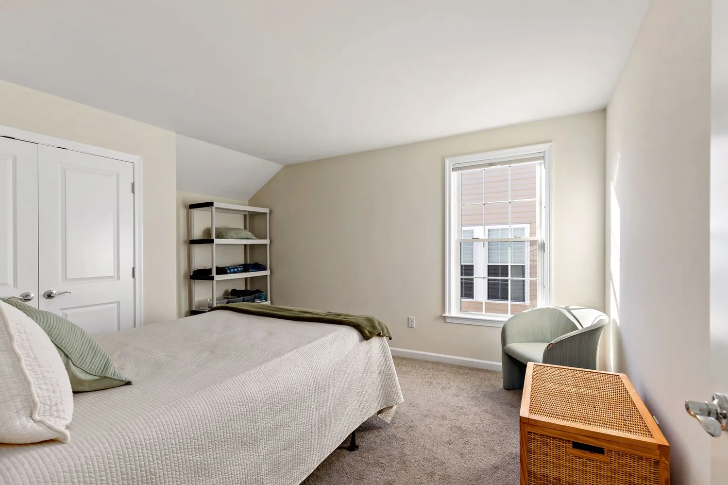 a bedroom with a bed couch and a window