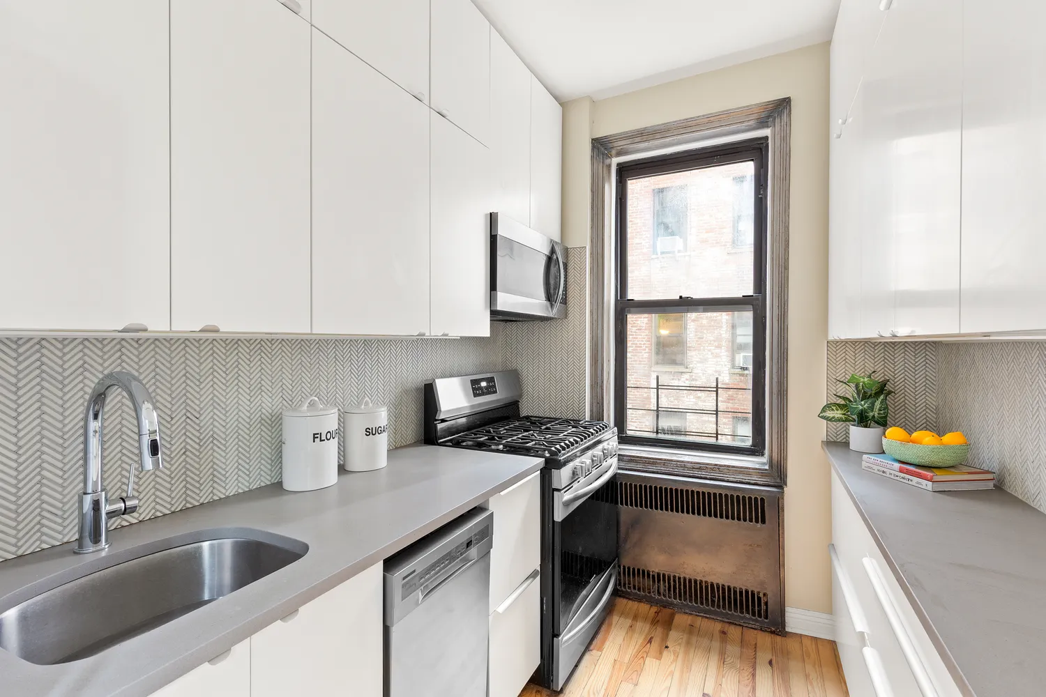 a kitchen with a sink a counter top space and cabinets