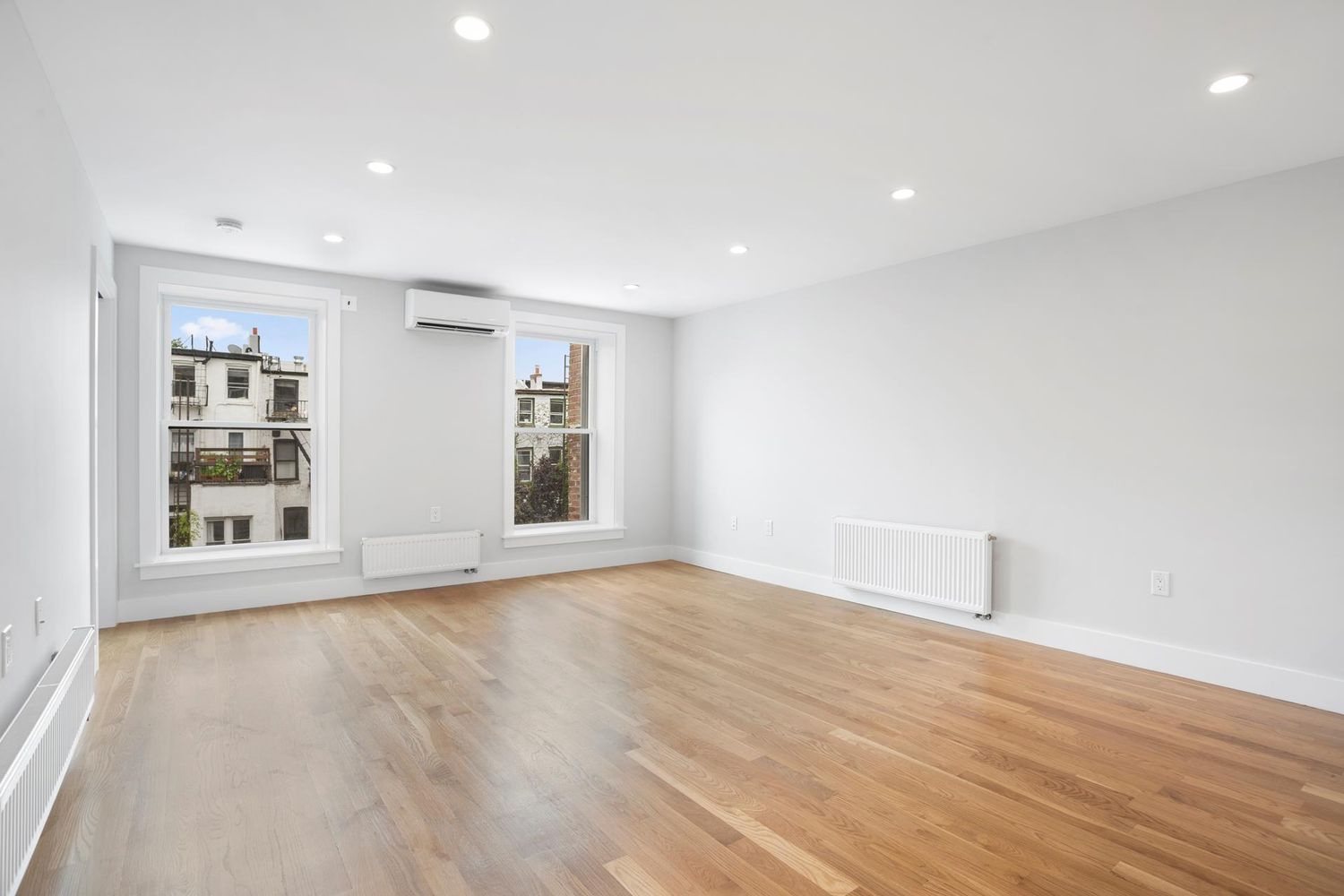 136 Union Street, Unit 2 Brooklyn, NY 11231 - Photo 2 of 9 a view of an empty room with wooden floor and a window
