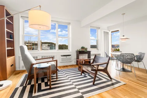 a view of a livingroom with furniture and a dining table