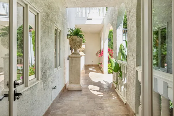 a view of a hallway to a livingroom with furniture and an entryway