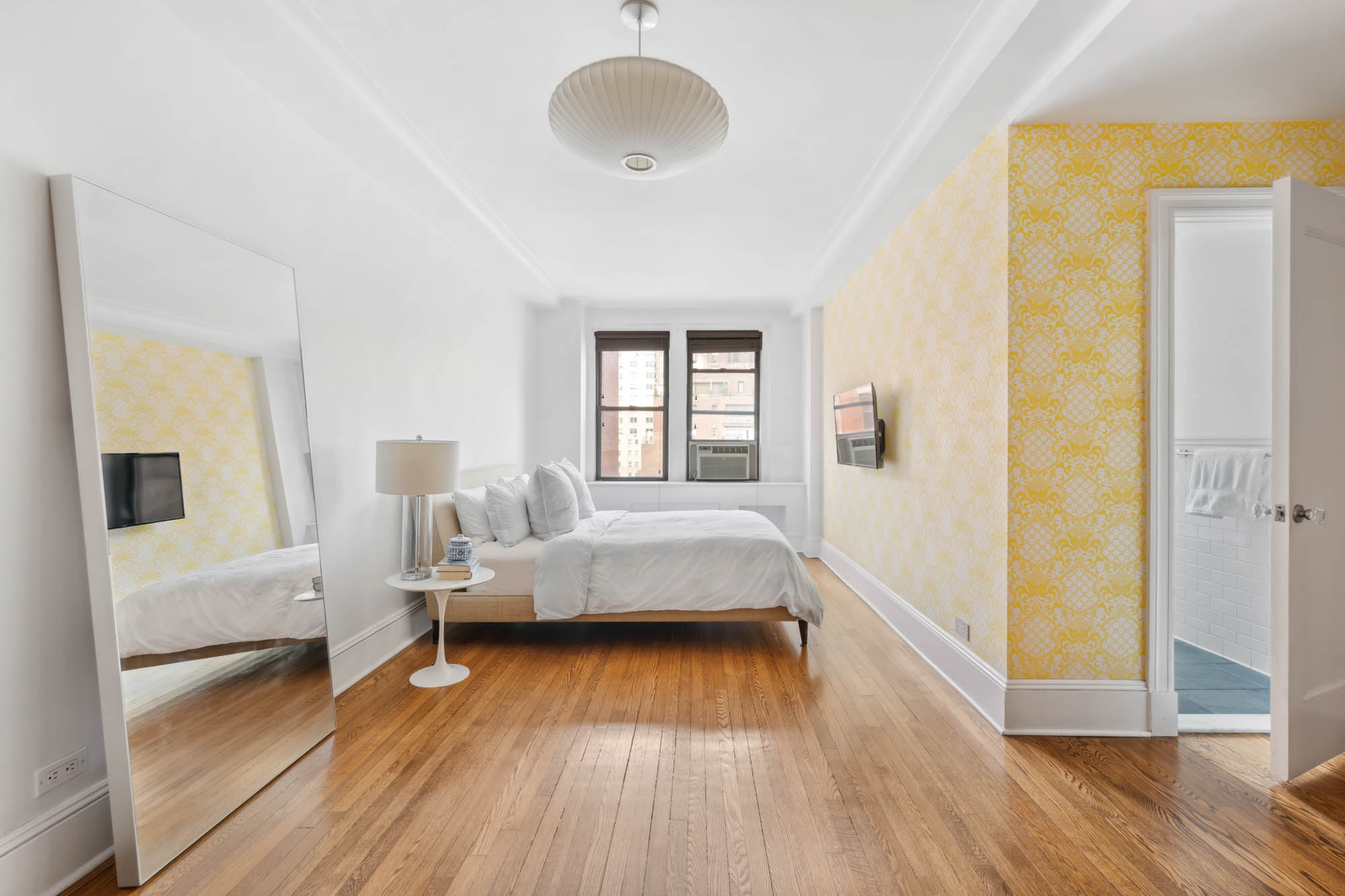 136 East 36th Street, Unit 9/10C Manhattan, NY 10016 - Photo 10 of 23 a bedroom with furniture and a wooden floor