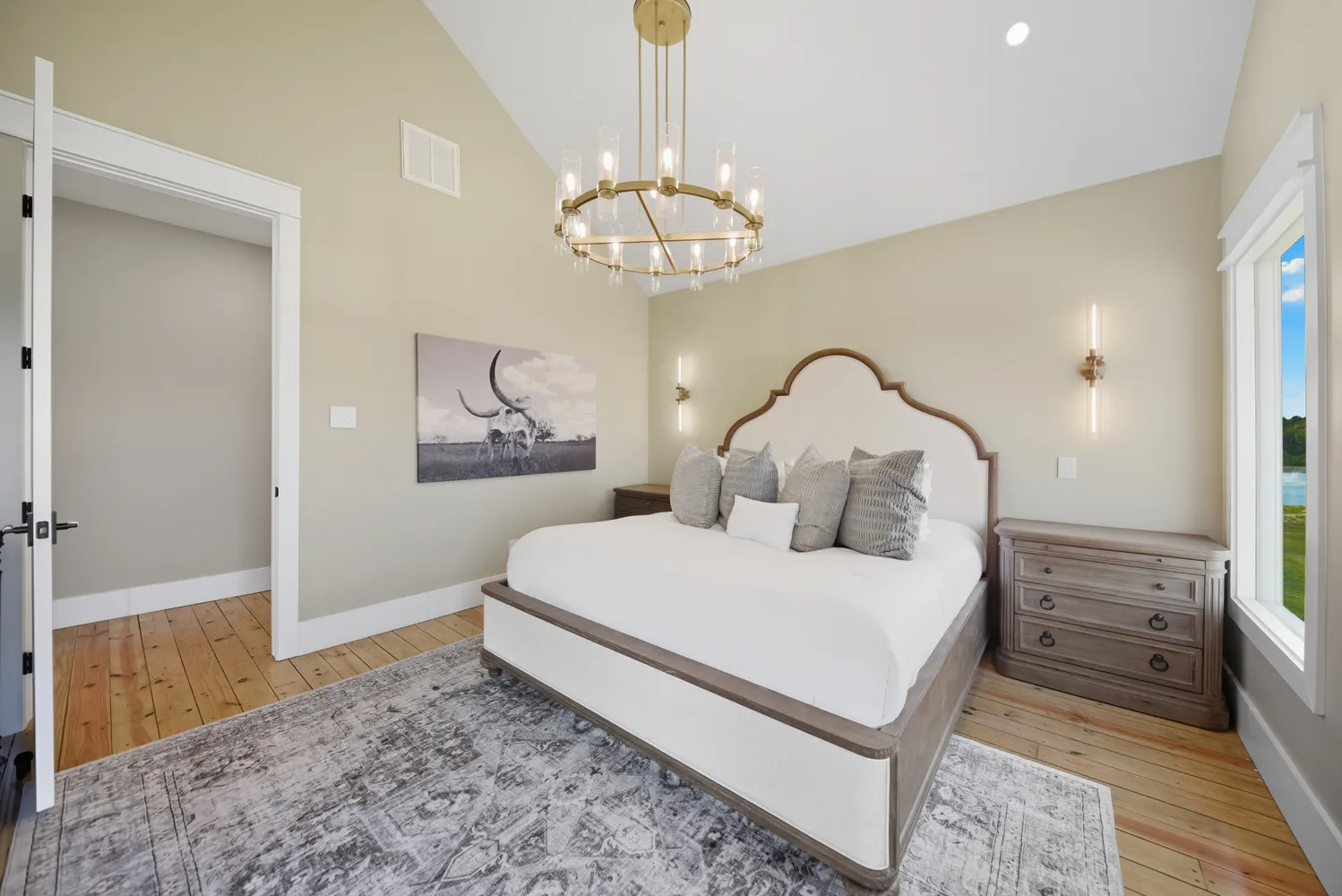 a dining room with furniture large windows and wooden floor