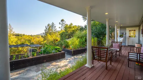 a view of a patio with table and chairs and wooden floor