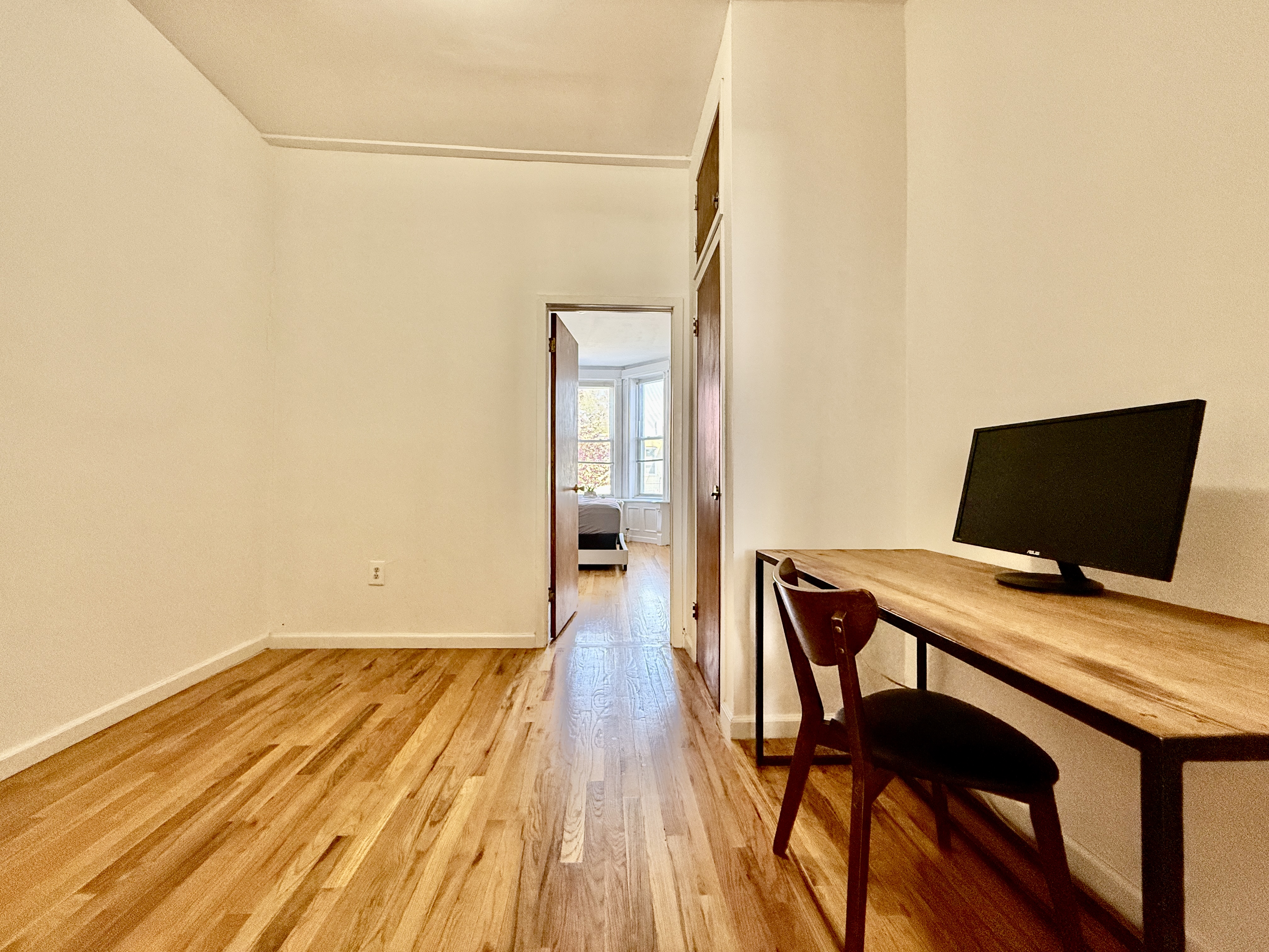 149 East 35th Street, Unit 2 Brooklyn, NY 11203 - Photo 8 of 10 a view of a workspace with furniture and wooden floor