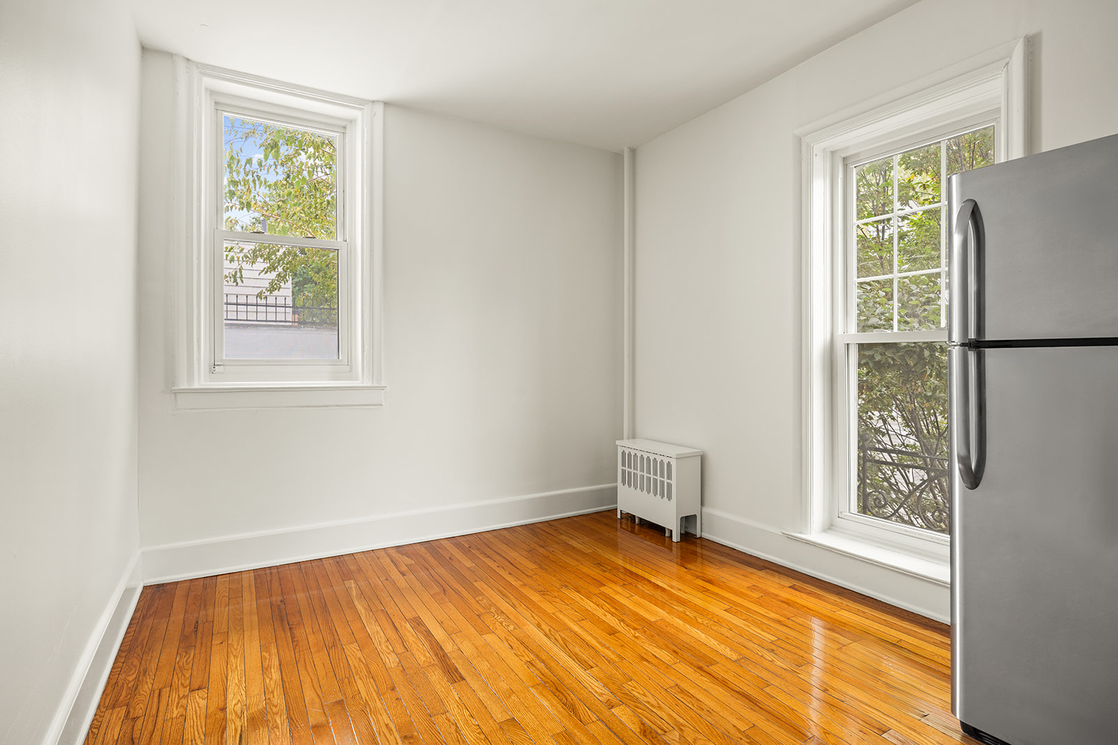 1523 11th Avenue, Unit 2 Brooklyn, NY 11215 - Photo 2 of 11 a view of empty room with wooden floor and fan