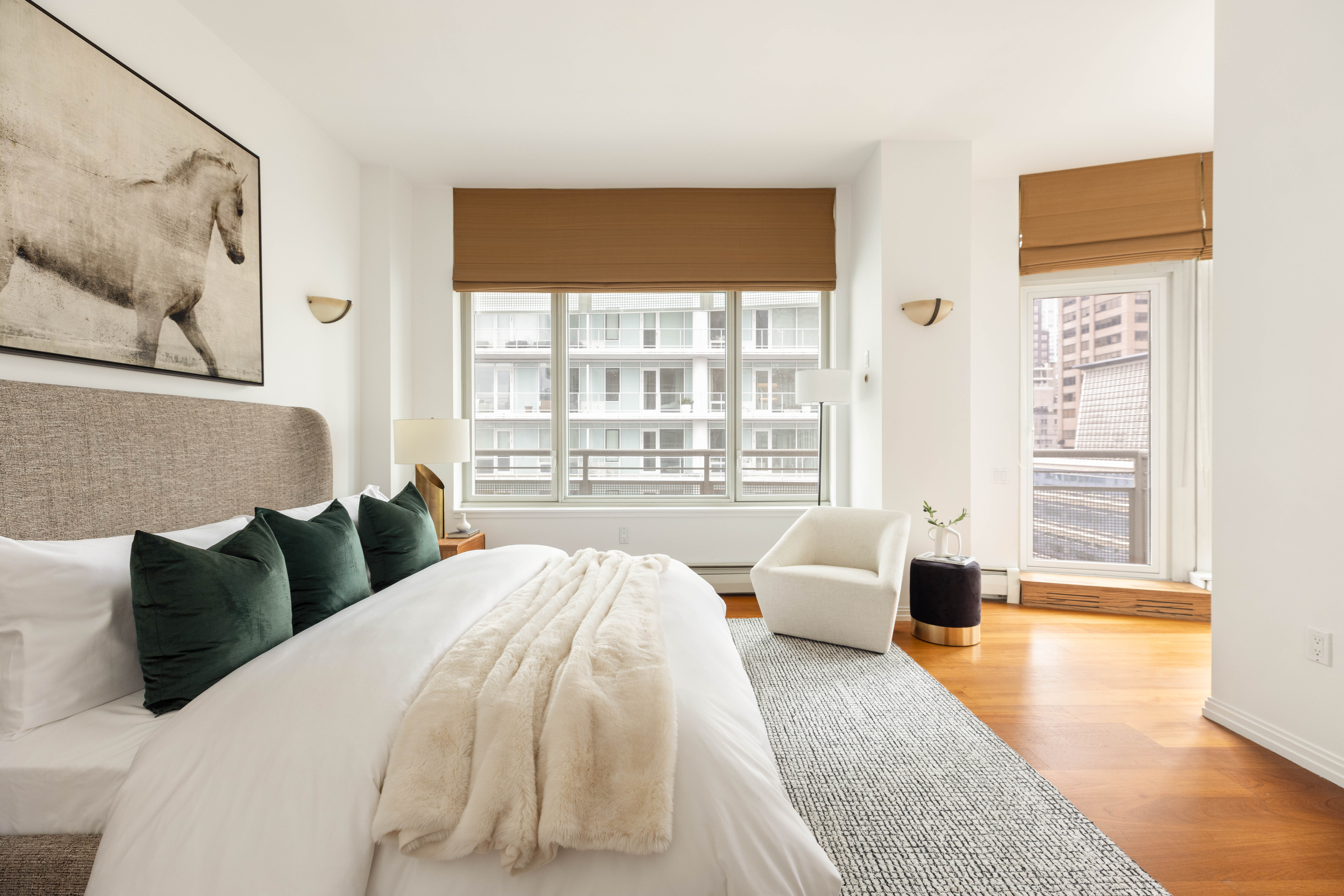 205 East 59th Street, Unit 14B Manhattan, NY 10022 - Photo 10 of 19 a spacious bedroom with a bed and wooden floor