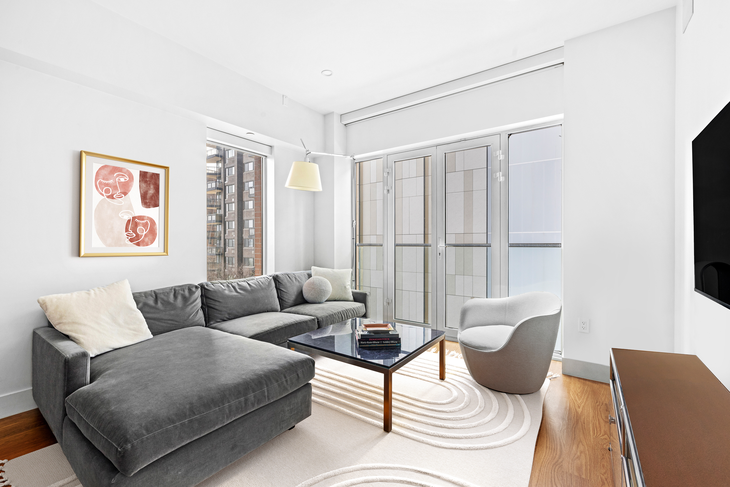 427 East 90th Street, Unit 5A Manhattan, NY 10128 - Photo 2 of 13 a living room with furniture and a window