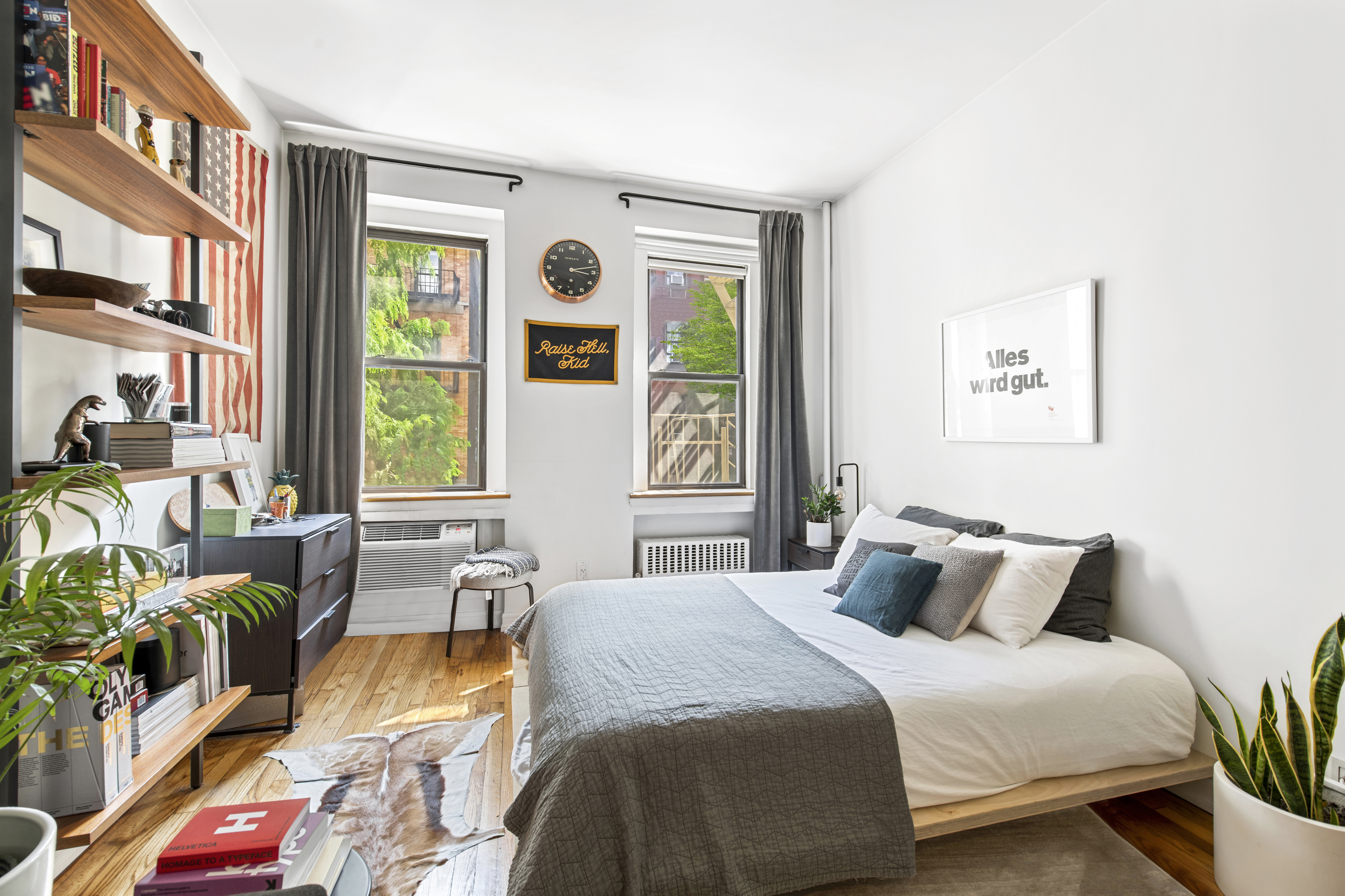 a bedroom with a bed and a large window