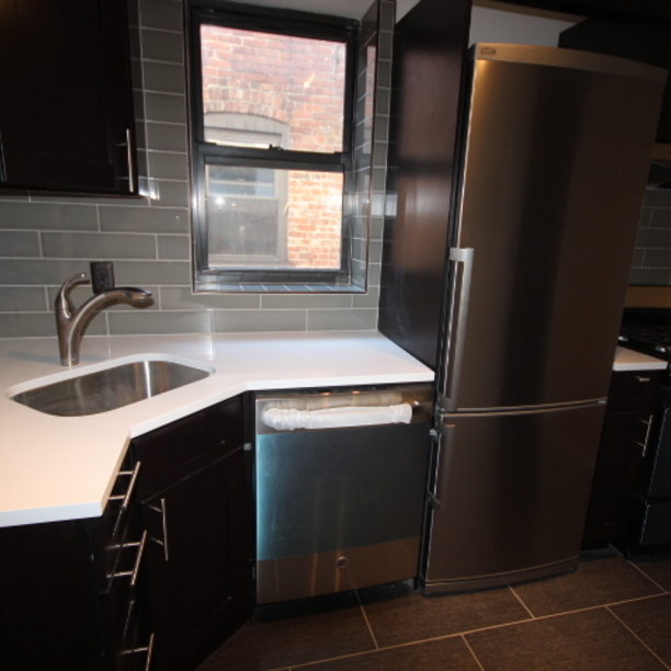 a kitchen with a sink a refrigerator and window