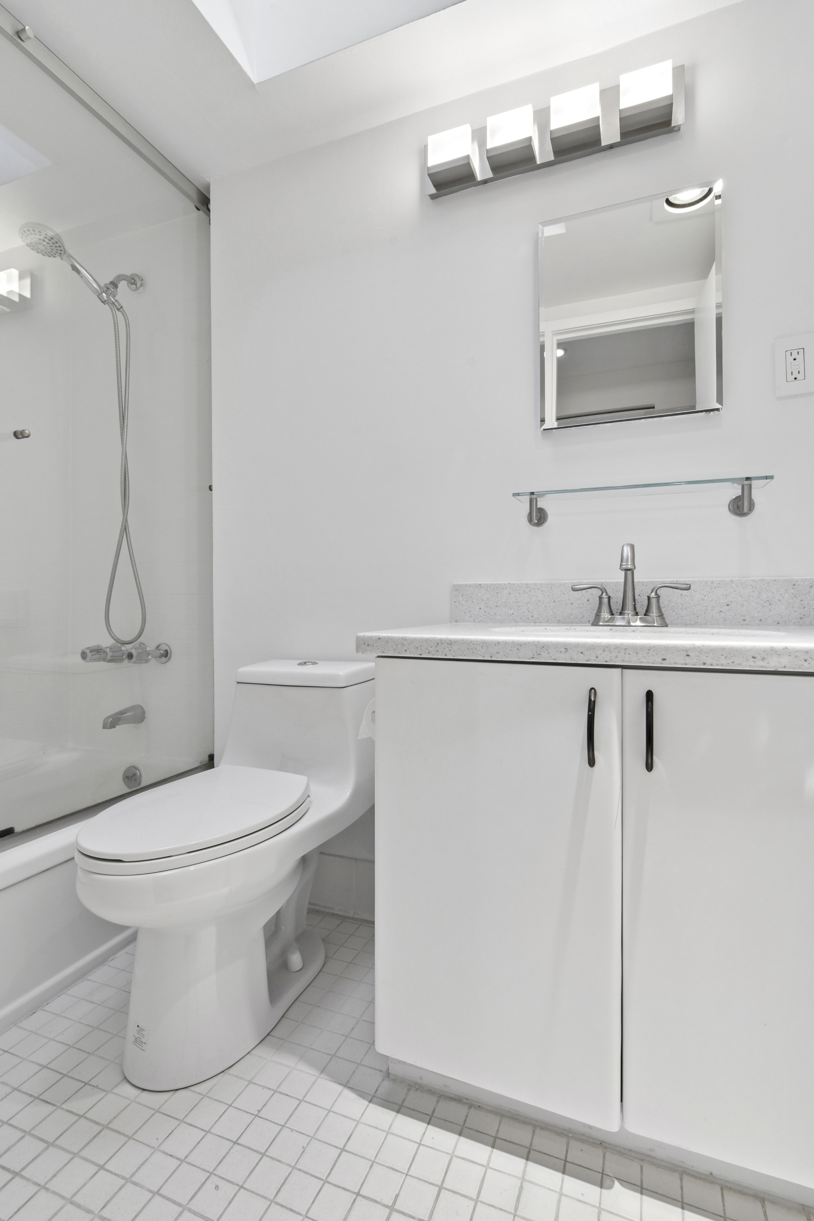 109 East 38th Street, Unit 3A Manhattan, NY 10016 - Photo 10 of 13 a bathroom with a toilet sink and mirror