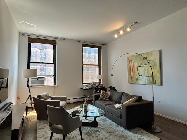 250 Mercer Street, Unit D603 Manhattan, NY 10012 - Photo 16 of 20 a living room with furniture and a window