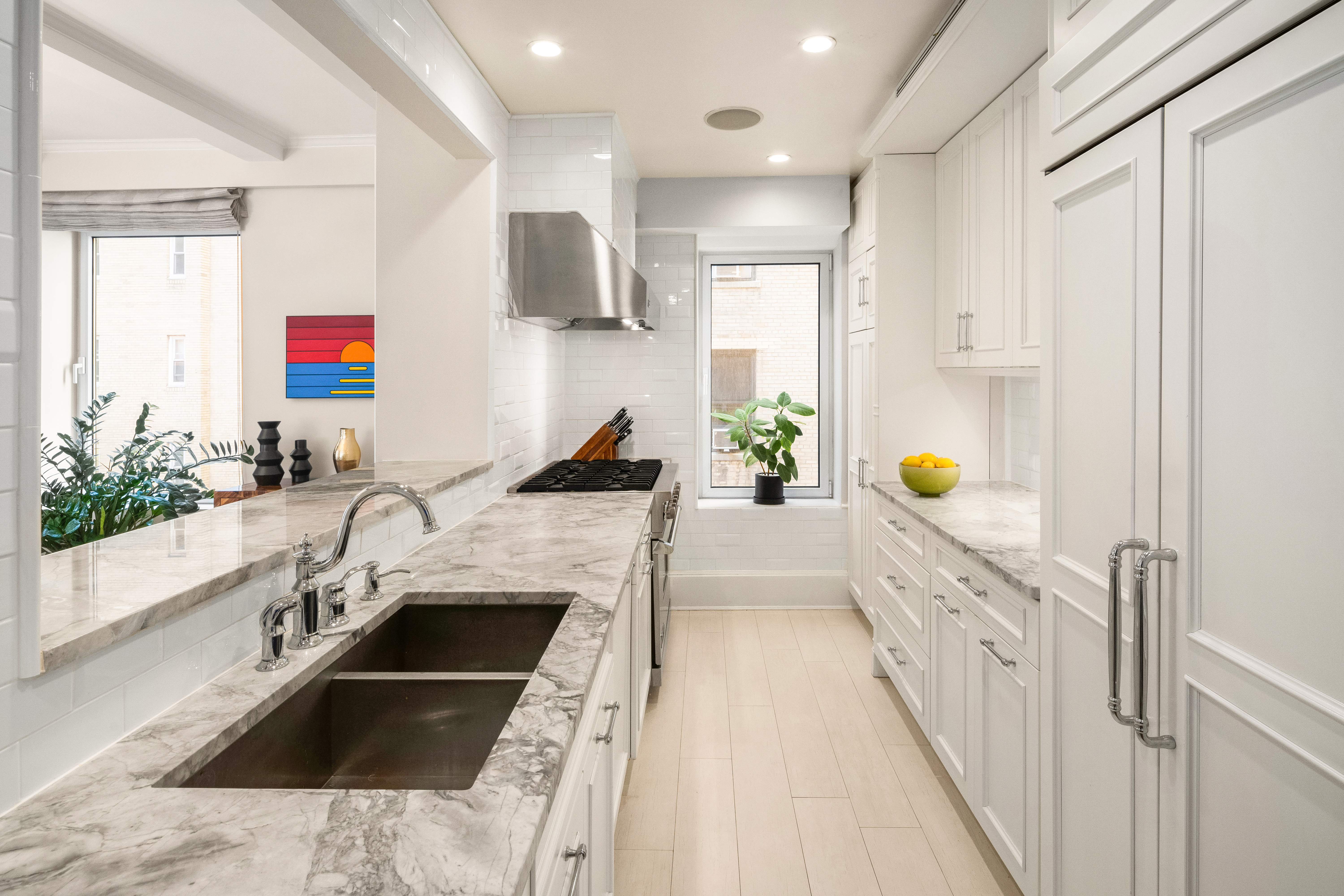 138 East 36th Street, Unit 4C Manhattan, NY 10016 - Photo 6 of 17 a kitchen with a sink stove and cabinets