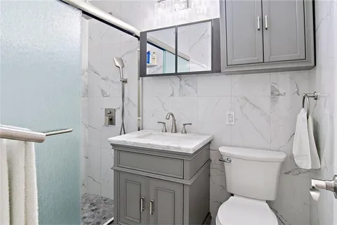 a bathroom with a toilet sink and mirror