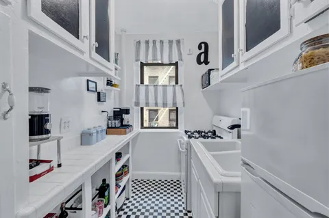a kitchen with stainless steel appliances a sink stove and refrigerator