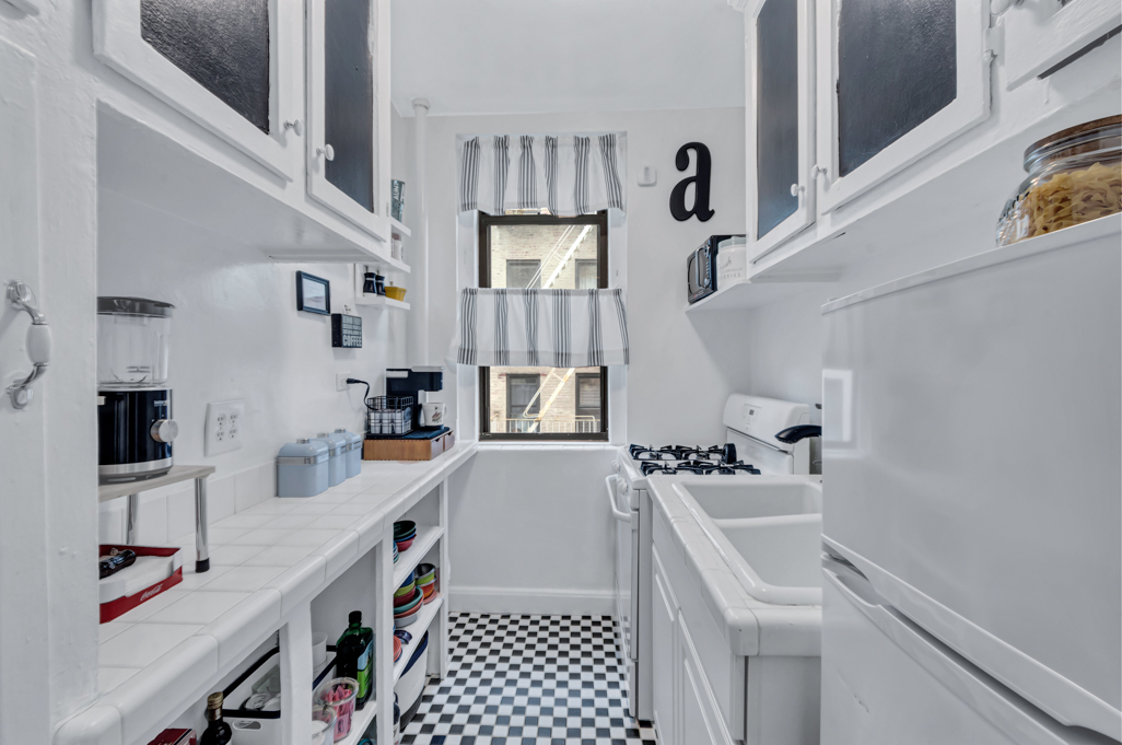 350 Cabrini Boulevard, Unit 6N Manhattan, NY 10040 - Photo 5 of 9 a kitchen with stainless steel appliances a sink stove and refrigerator