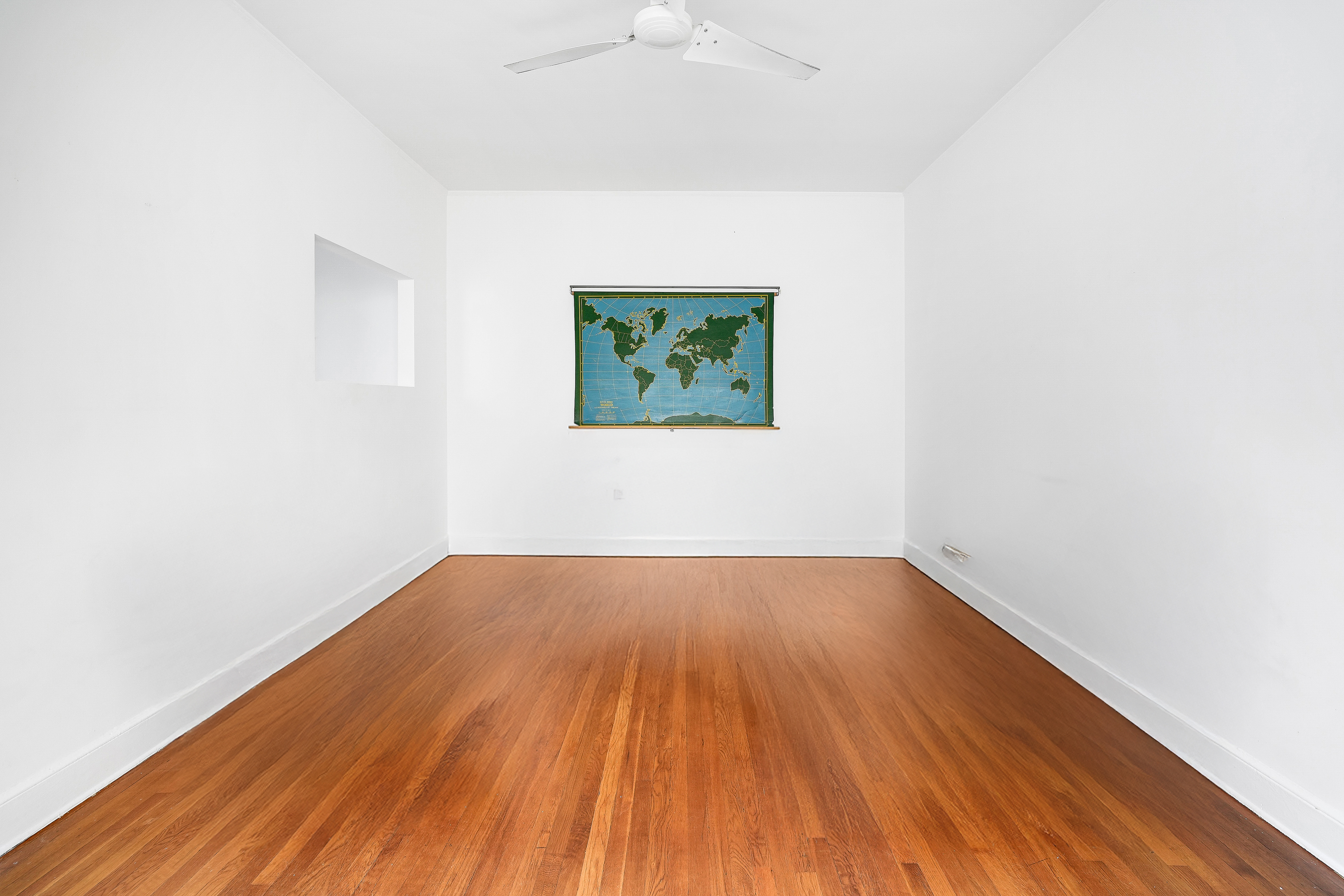 215 West 105th Street, Unit 5DPH Manhattan, NY 10025 - Photo 5 of 16 an empty room with wooden floor and windows
