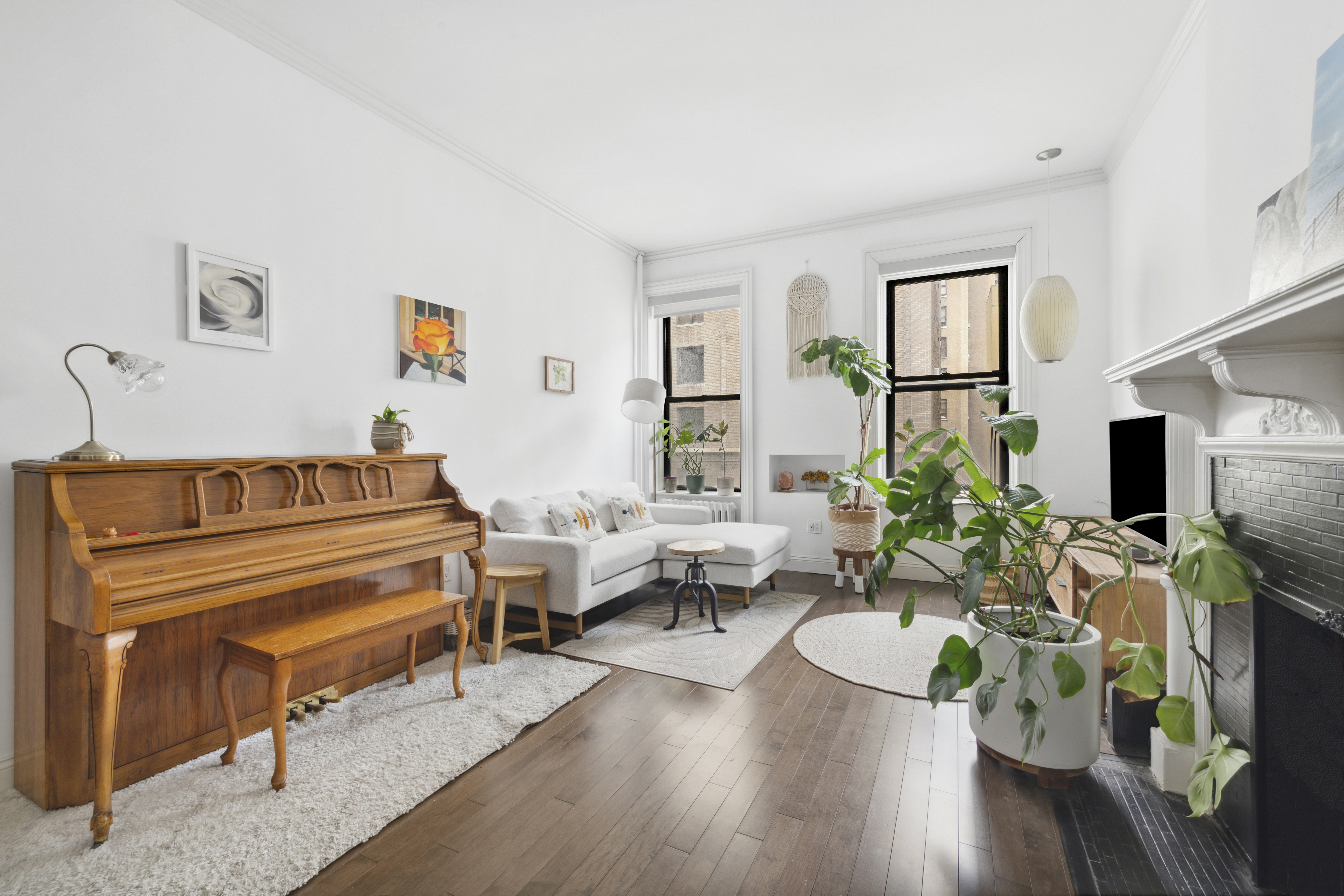 332 West 101st Street, Unit 4F Manhattan, NY 10025 - Photo 2 of 10 a living room with furniture fireplace and a potted plant