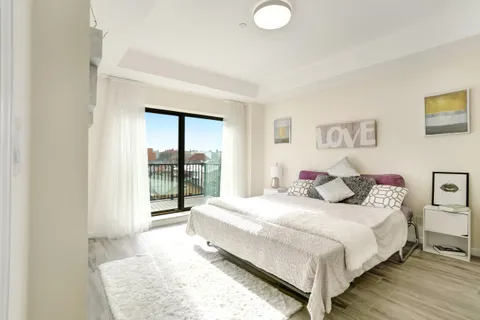 a bedroom with a bed and a large window