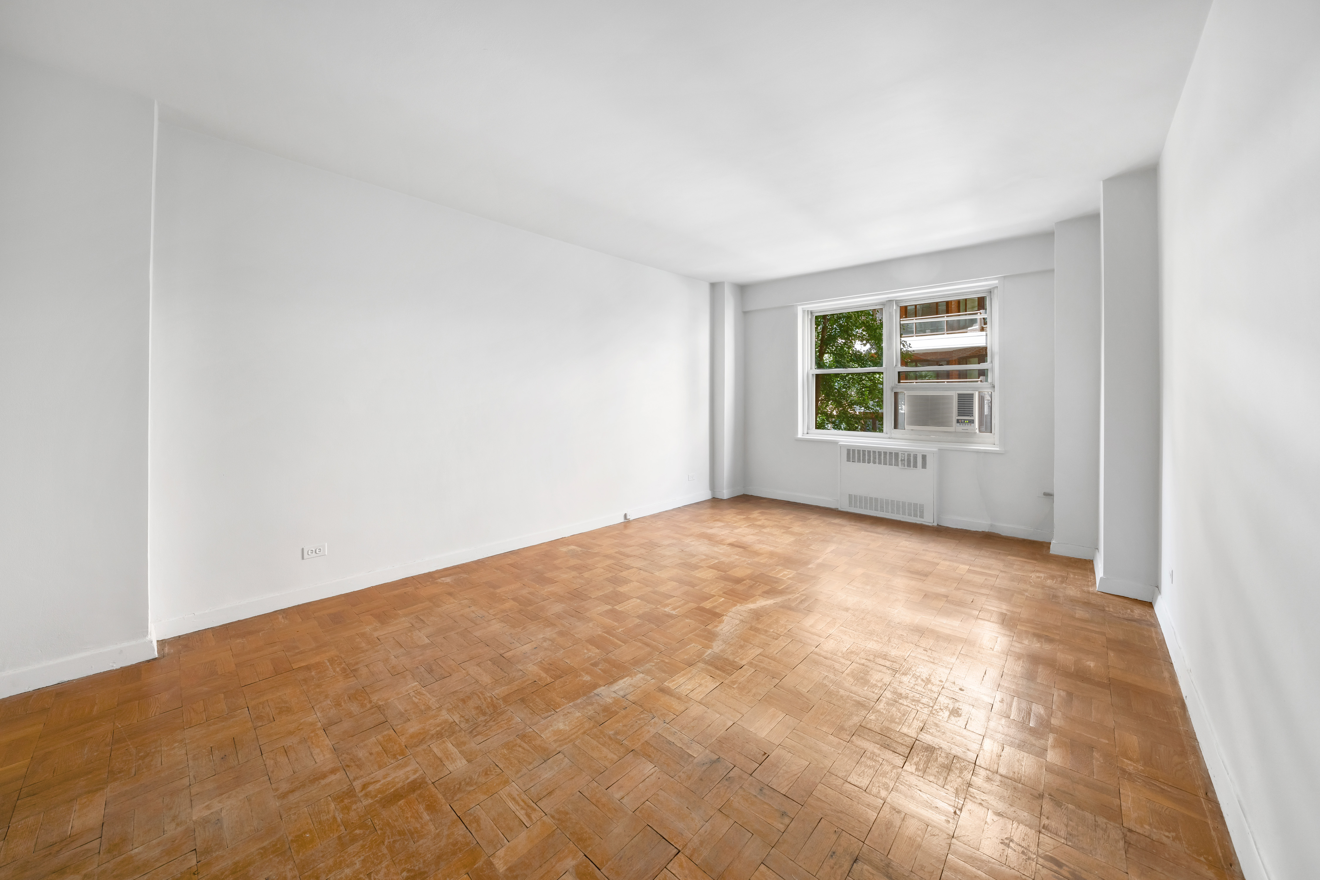50 Sutton Place South, Unit 5E Manhattan, NY 10022 - Photo 9 of 13 an empty room with windows
