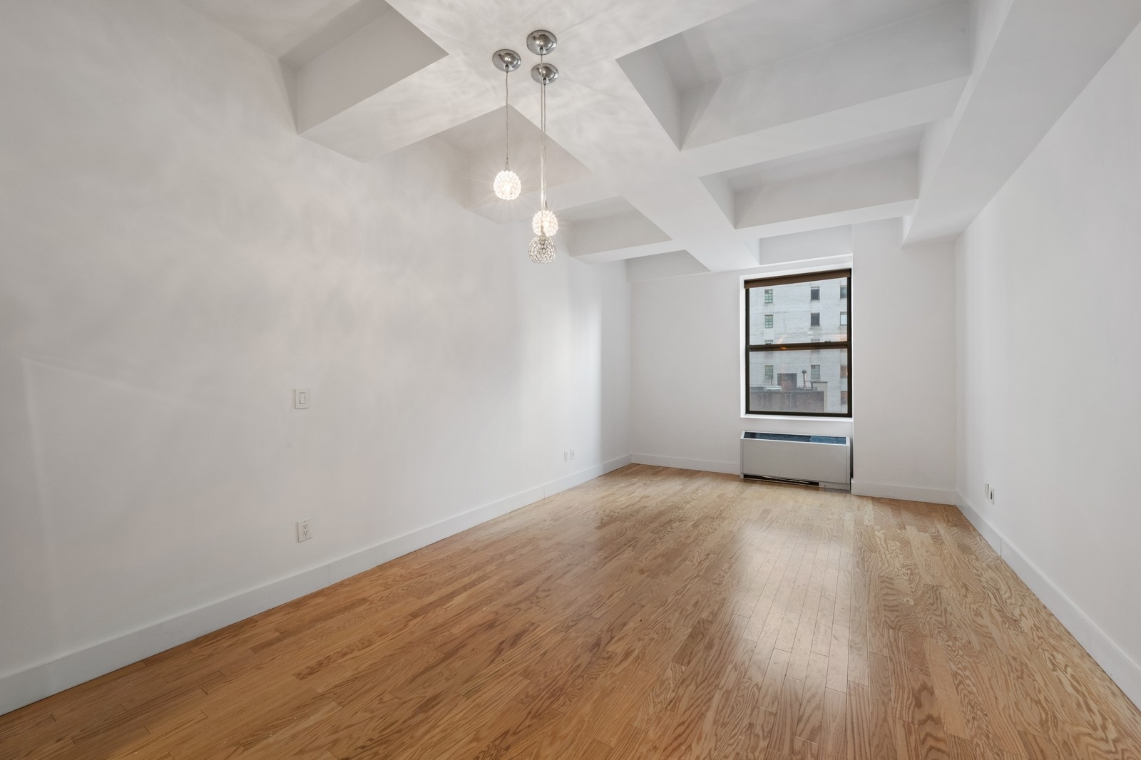 99 John Street, Unit 1711 Manhattan, NY 10038 - Photo 4 of 14 wooden floor in an empty room with a window
