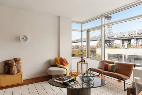 a living room with furniture and a floor to ceiling window