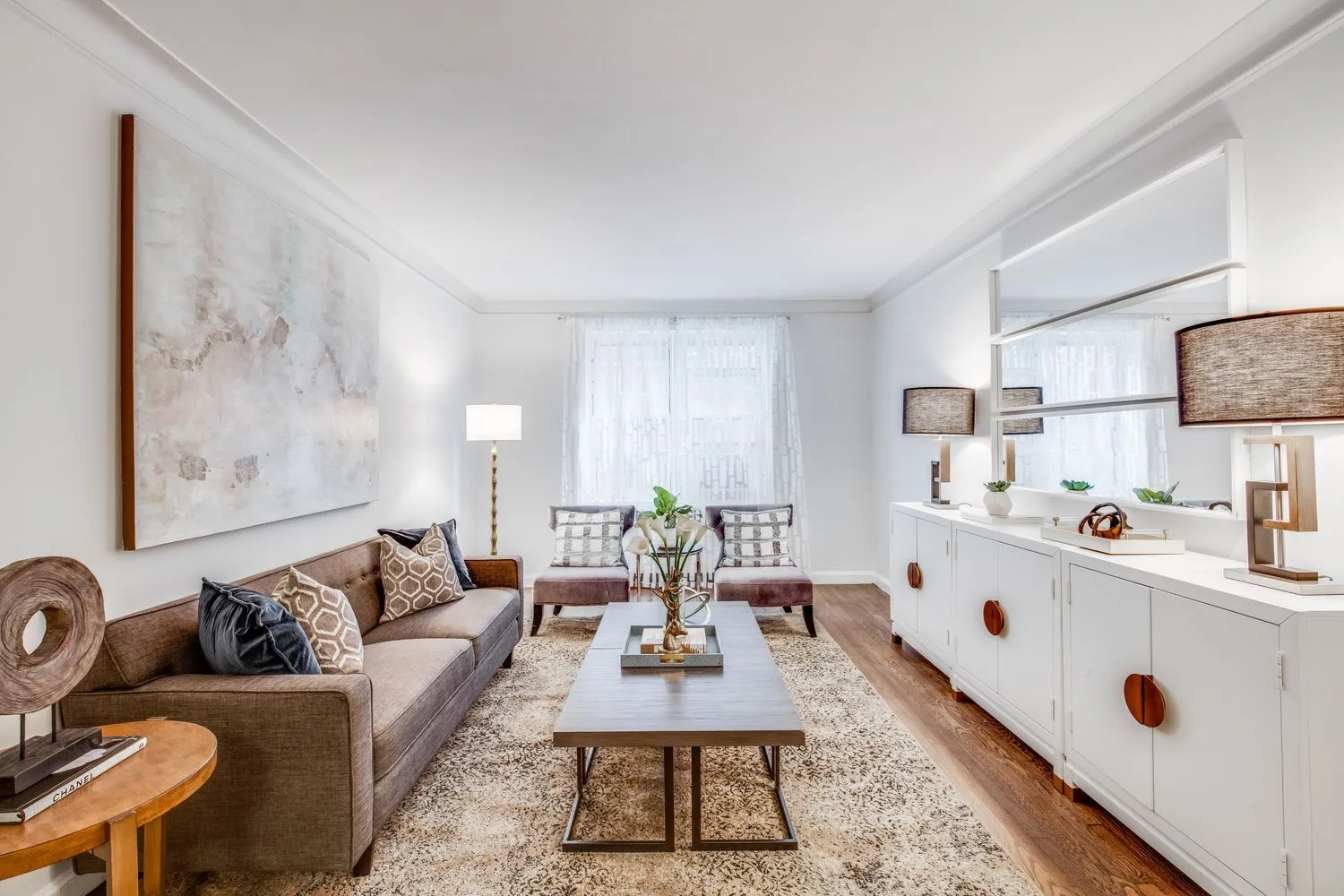 a living room with furniture a rug and a table