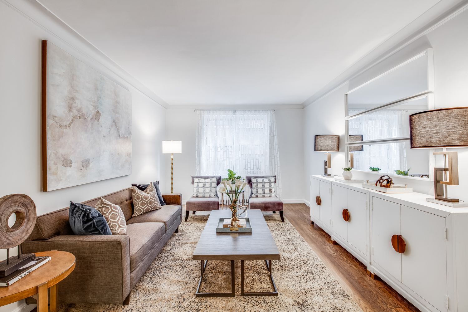 300 West 53rd Street, Unit 3C Manhattan, NY 10019 - Photo 3 of 10 a living room with furniture a rug and a table