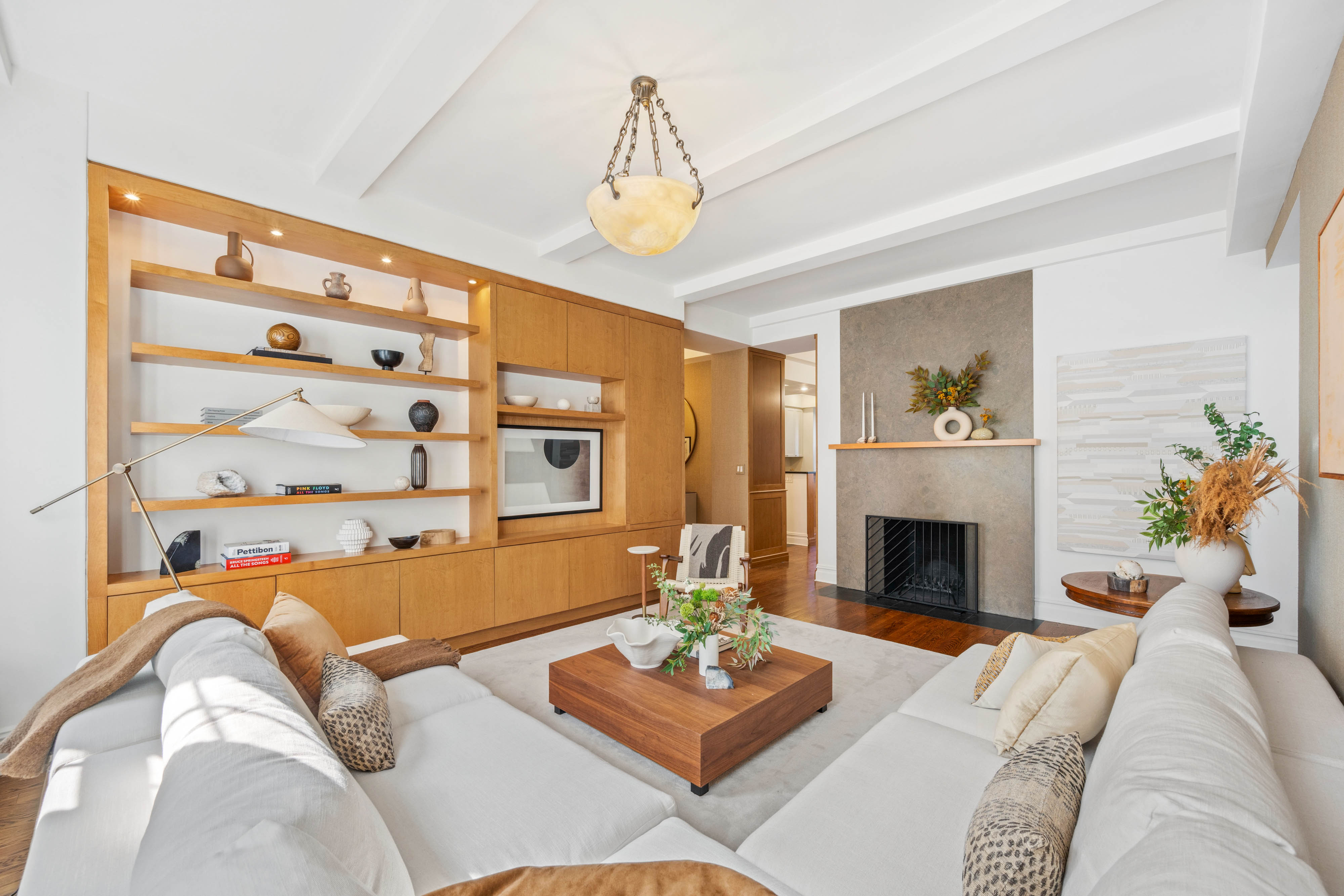 25 5th Avenue, Unit 6C Manhattan, NY 10003 - Photo 3 of 16 a living room with furniture and a fireplace