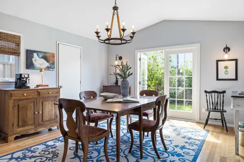 a view of a dining room with furniture wooden floor and chandelier