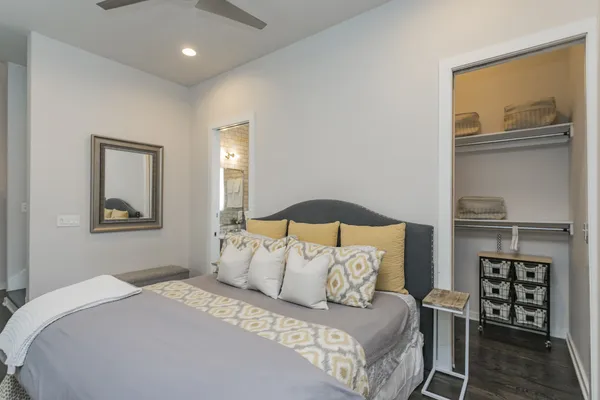 a bedroom with a large bed and a painting on the wall